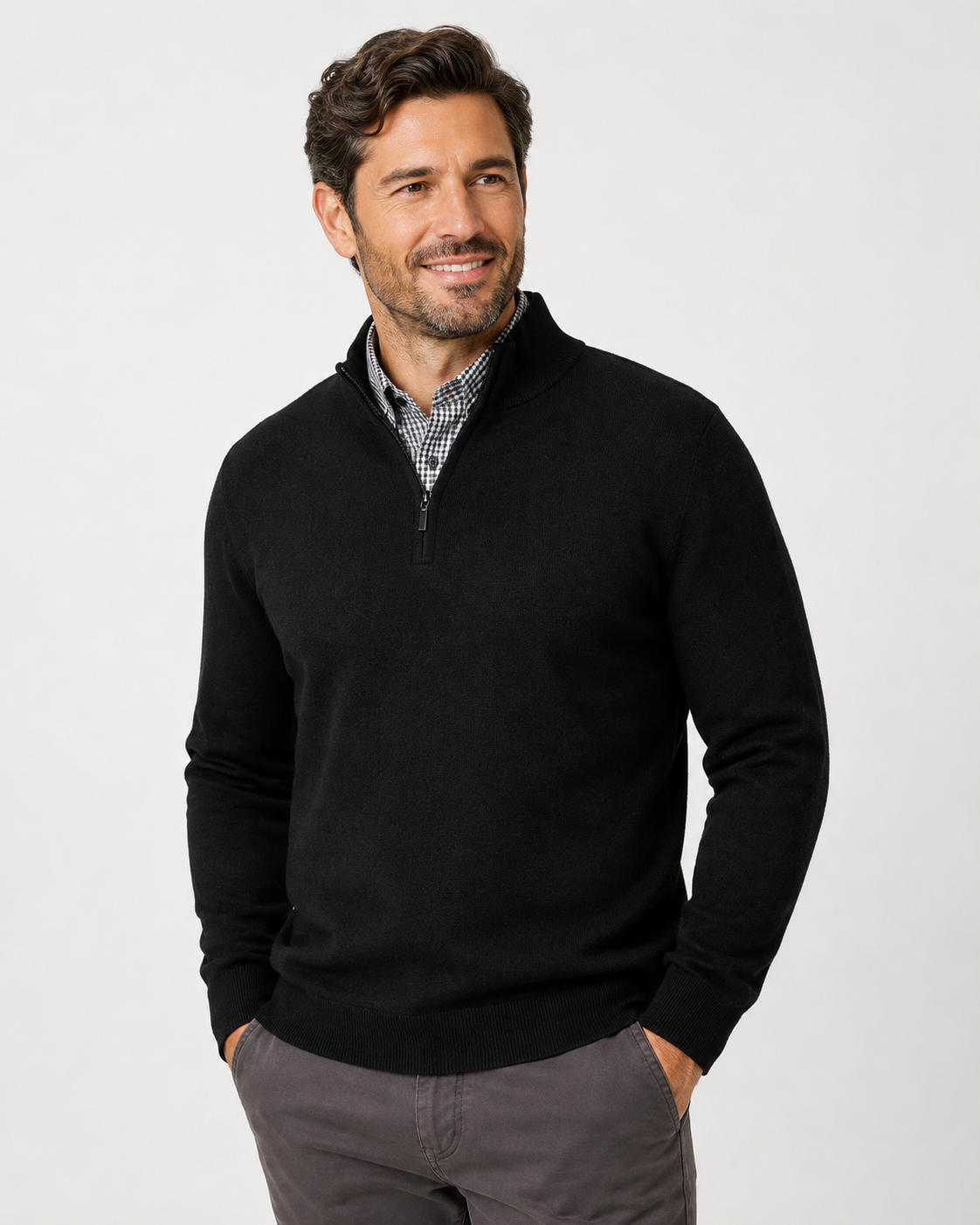 A man wearing a black quarter-zip knit sweater 